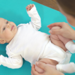 Cute healthy baby. Massage baby. The body care. The hands of the mother. The love of parents. Medical procedures.